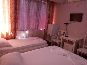 Postel nebo postele na pokoji v ubytování British Hotel