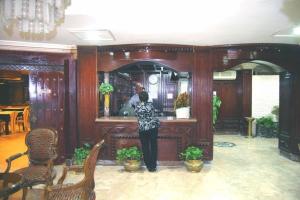 a woman standing at a bar in a room at Nile Zamalek Hotel in Cairo