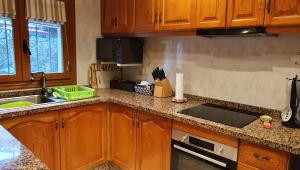 a kitchen with wooden cabinets and a counter top at Las Bellotas in Moraira