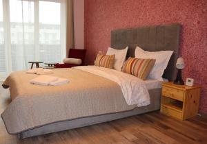 a bedroom with a large bed with two towels on it at All Homes by Nati in Braşov