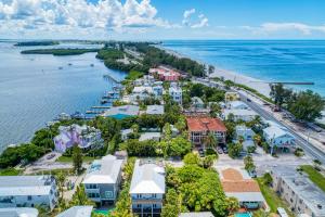 an aerial view of a resort next to the ocean at Cottage Haven-One Minute Walk To The Beach-Private Yards-Keyless Locks in Bradenton Beach