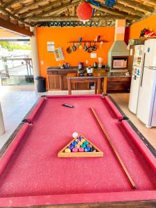 a pool table with balls in the middle of a kitchen at Rosamar Suites in Praia do Rosa