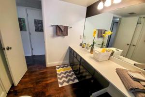 a bathroom with a sink and a large mirror at 4 Mi to Beach Lake Havasu Apartment with Pool! in Lake Havasu City
