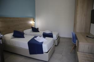Postel nebo postele na pokoji v ubytování Oasi Guzzetta Hotel&Case Vacanze