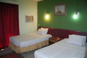 Ένα ή περισσότερα κρεβάτια σε δωμάτιο στο Nile Zamalek Hotel