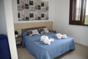 Postel nebo postele na pokoji v ubytování Oasi Guzzetta Hotel&Case Vacanze