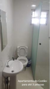 a bathroom with a toilet and a sink and a shower at De frente para o Mar da Gamboa in Garopaba +15 photos