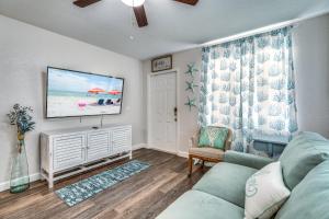 a living room with a couch and a flat screen tv at Cortez Gardens Cottage 11, Renovated, Close to Beach, 3-Bed, 2 Bath 10 people in Bradenton