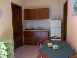 a kitchen with a table with two cups on it at Masseria Asciano in Ostuni