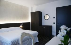 a hotel room with a bed and a mirror at B&B Riva del Gallo in Tresigallo