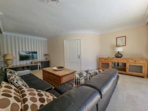 a living room with a couch and a table at Beachfront Villa Torrox Costa in Torrox Costa