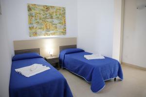 Postel nebo postele na pokoji v ubytování Oasi Guzzetta Hotel&Case Vacanze