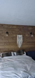 a bedroom with a bed with a wooden head board at Luxury Central Apartment MONTCHAVIN in Bellentre