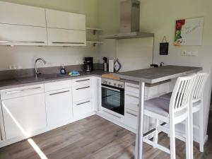 a kitchen with white cabinets and a counter top at Ferienwohnung am Welper-Wald-Vechta-Süd in Vechta