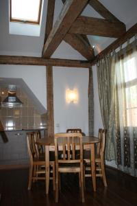 a dining room with a wooden table and chairs at Goldingen in Kuldīga +14 photos