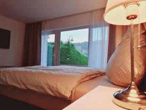 a bedroom with a bed and a large window at Moseltraum in Traben-Trarbach