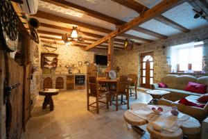 a living room with a couch and tables and a fireplace at Holiday home Leptir in Siverić