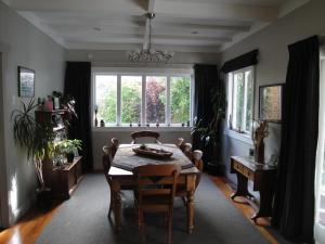 a dining room with a table and a window at English Tudor House in Hamilton