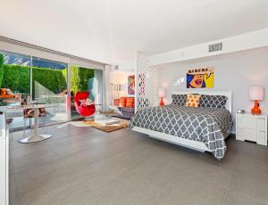a bedroom with a bed and a living room at The Twist Palm Springs in Palm Springs