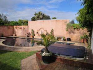 a backyard with a swimming pool and a house at English Tudor House in Hamilton