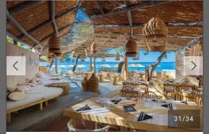 a restaurant with tables and chairs and the ocean at APARTMANI Mila in Podstrana