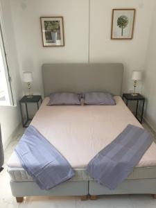 a bedroom with a large bed with blue pillows at Luxury apartment Korcula - Villa Sunny Days in Korčula