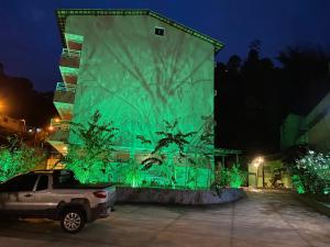 a truck parked in front of a building at night at Apart Hotel Angra dos Reis II in Angra dos Reis