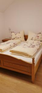 a bed with a wooden frame in a room at Ferienwohnung Eisl in St. Wolfgang