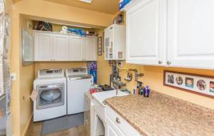a kitchen with a washing machine and a sink at Chalet 5 Aspens, Your Exclusive High Country Escape in Prescott