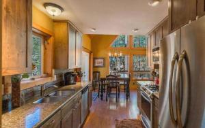 a kitchen with a stainless steel refrigerator and a dining room at Chalet 5 Aspens, Your Exclusive High Country Escape in Prescott