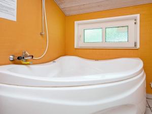 a bathroom with a white tub and a window at Luxury Retreat near Kvie So - By Traum Ferienwohnungen in Ansager +29 photos