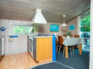 a kitchen and dining room with a table and chairs at Luxury Retreat near Kvie So - By Traum Ferienwohnungen in Ansager