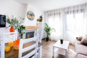 a living room with a couch and a fireplace at Casa rural Torre Buena Vista a 40 minutos de Valencia con gran jacuzzi y vistas maravillosass in Benafer