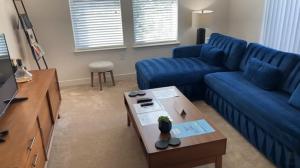 阿什本的住宿－National at Loudoun，客厅配有蓝色的沙发和桌子