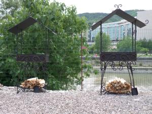 a cage filled with wood in front of a fence at Guest House Admiral in Nebug