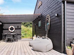 a patio with a chair and a table on a deck at 4 person holiday home in S nder Stenderup in Sønder Stenderup
