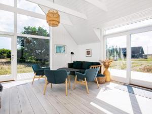 a living room with a couch and chairs at 10 person holiday home in Skagen in Skagen