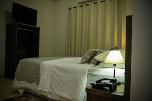 Hotel D'Nápoles tesisinde bir odada yatak veya yataklar