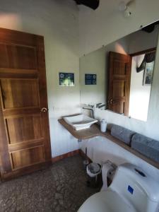 a bathroom with a toilet and a sink and a mirror at Las Cabezas Grises in Barichara +67 photos