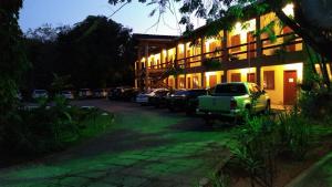 a car parked in front of a building at night at Pousada Circuito das Aguas in Jaguariúna