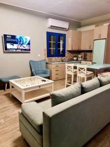 a living room with a couch and a table at KERAME PARADISE VILLA in Agios Kirykos