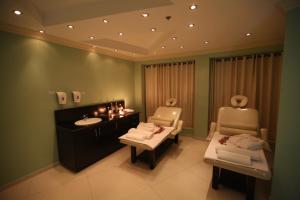 a bathroom with two chairs and a sink at Palestine Plaza Hotel in Ramallah