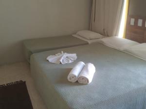 Łóżko lub łóżka w pokoju w obiekcie Pousada Boi Bumbá Praia