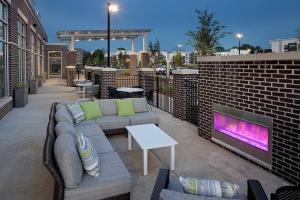 a patio with a couch and a tv and a brick wall at Hyatt Place Murfreesboro in Murfreesboro