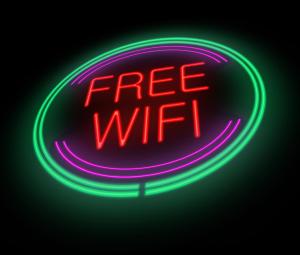 Un letrero de neón con la palabra wifi gratis en Days Inn by Wyndham McDonough, en McDonough