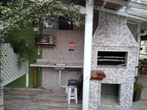 una cocina al aire libre con horno de piedra y fregadero en RECANTO RAVI, en Florianópolis