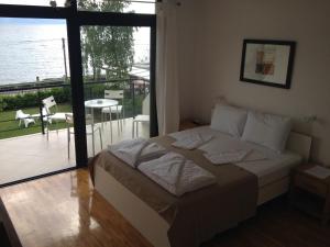 a bedroom with a bed and a view of a balcony at Villa Katerina in Ohrid