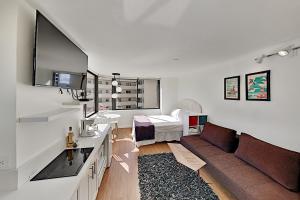 a white living room with a couch and a sink at Hawaiian Monarch 1603 condo in Honolulu