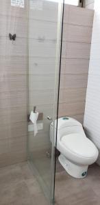 a bathroom with a toilet and a glass shower at Casa frente al Mar EL PARAISO, Cojimies in Pedernales +28 photos