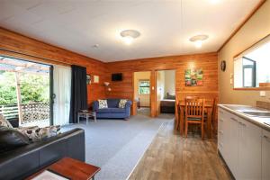 a living room with a couch and a table at Kaka Retreat Motel, Stewart Island in Half-moon Bay